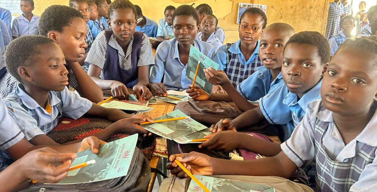 Group of school children holding books